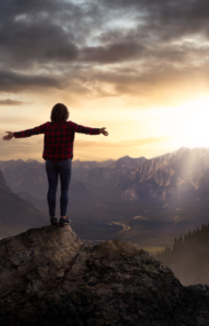 person standing on top of mountain