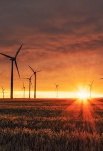 windmill on grass field during golden hour